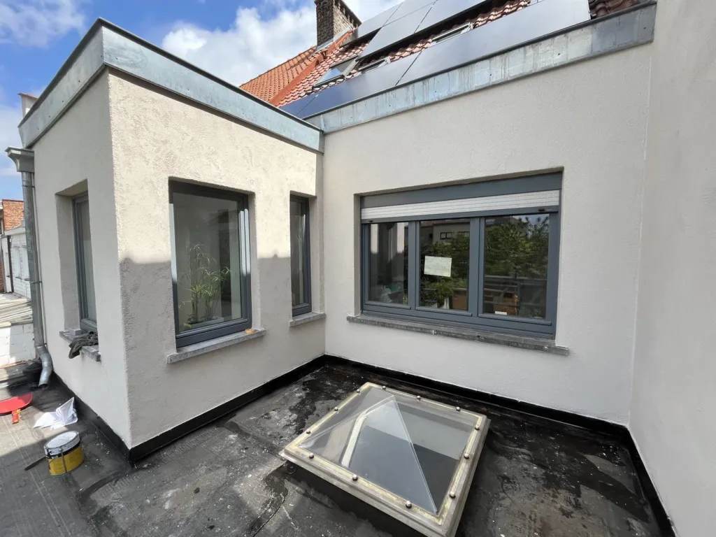 La même annexe après travaux, finition claire et texturée, lanterneau sur la toiture plate