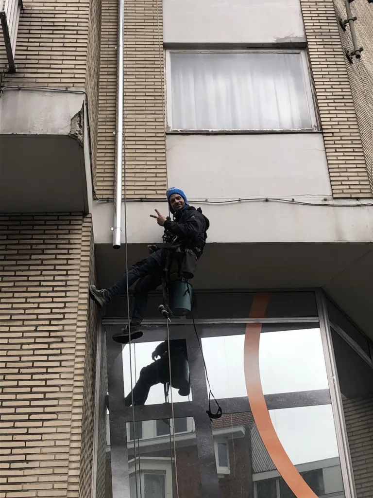 Cordiste travaillant en partie basse de la façade