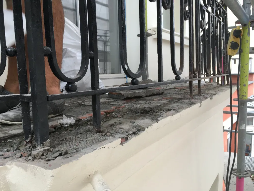 Intervention sur le support du balcon depuis l'échafaudage